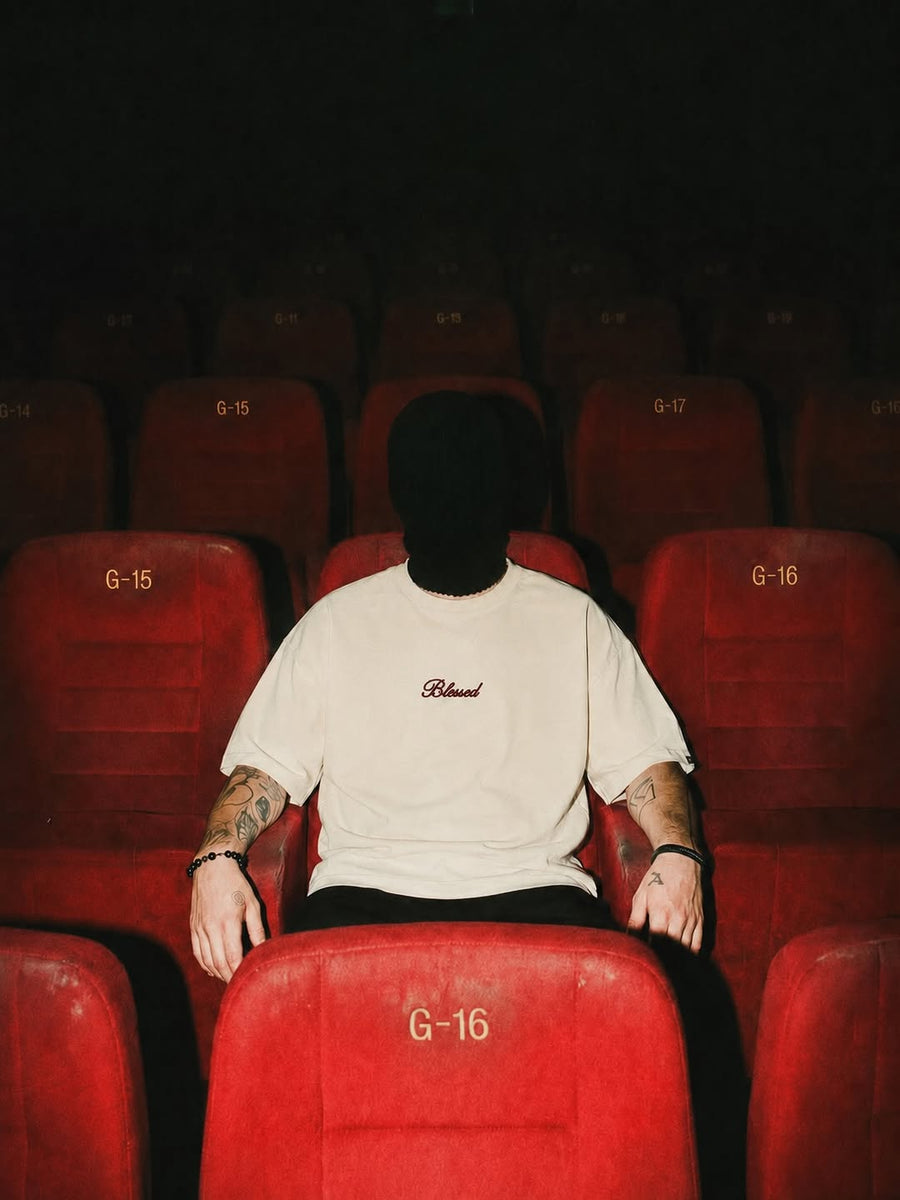 An empty theatre, rows of red velvet seats